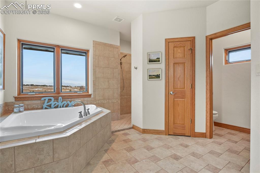 Image 18 of 50: Huge jetted tub and walk in oversized shower
