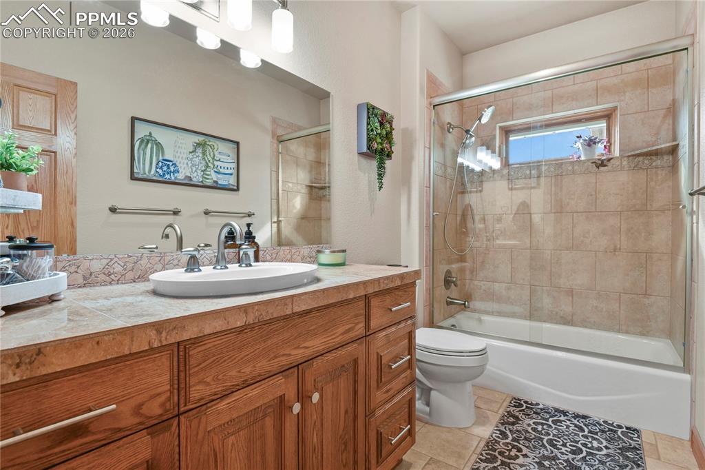 Image 20 of 50: Main level hall bathroom, new shower glass and lighting