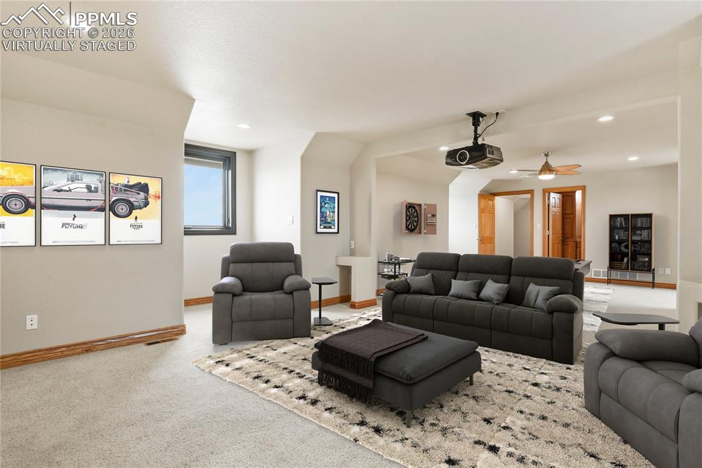 Image 34 of 50: Expansive Media/guest/hobby room over the 4 car garage. Virtually Staged 