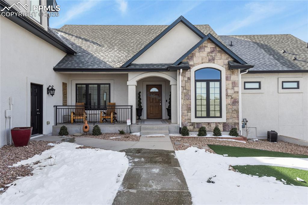 Image 4 of 50: Landscaped area leading to front door