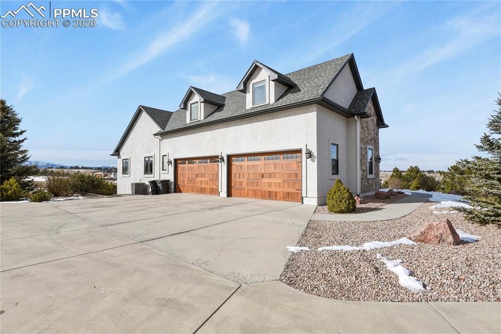 Image 42 of 50: New insulated carriage style garage doors, all concrete approach and drivew