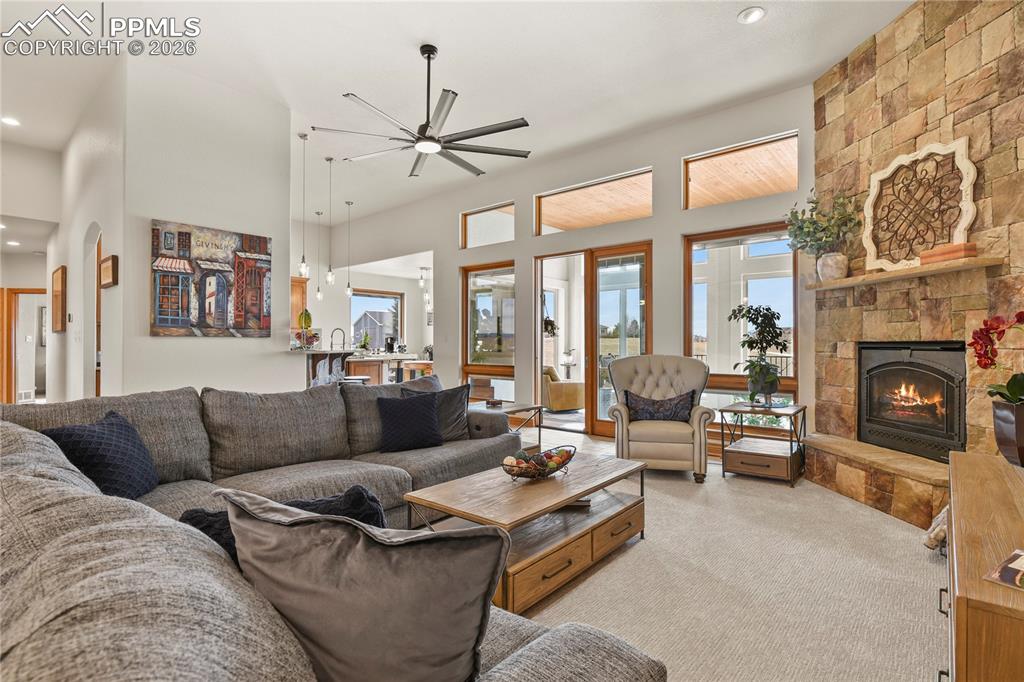Image 5 of 50: Main level great room with stone surround and gas fireplace