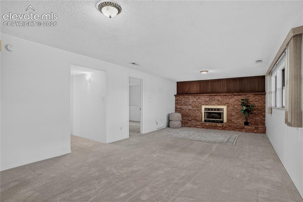 Image 16 of 21: Family room w/ fire place - lower level