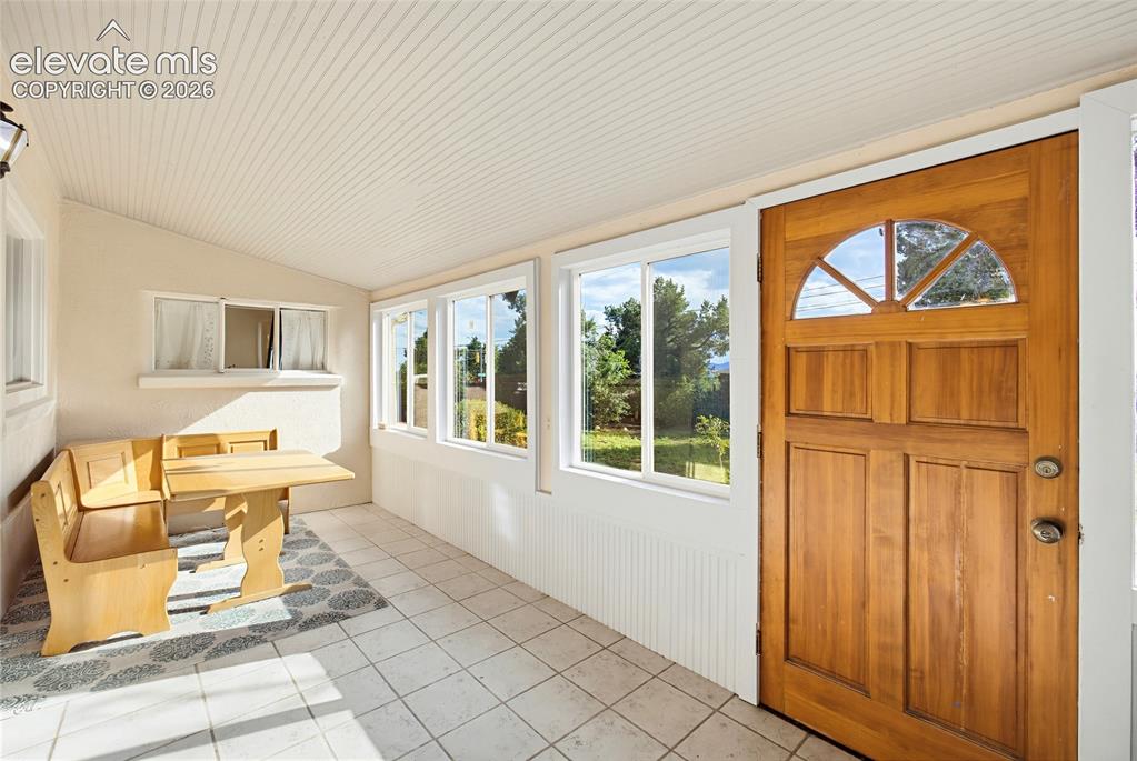 Image 11 of 42: Front porch sunroom