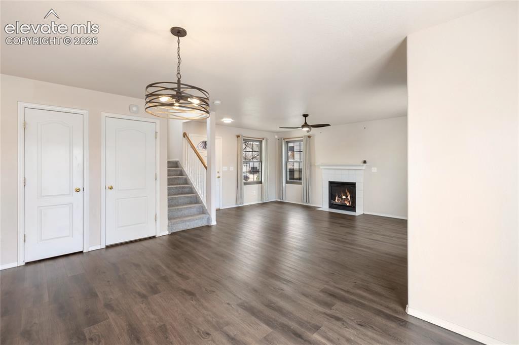 Image 10 of 38: Spacious open-concept interior featuring wood-finish flooring, a contempora