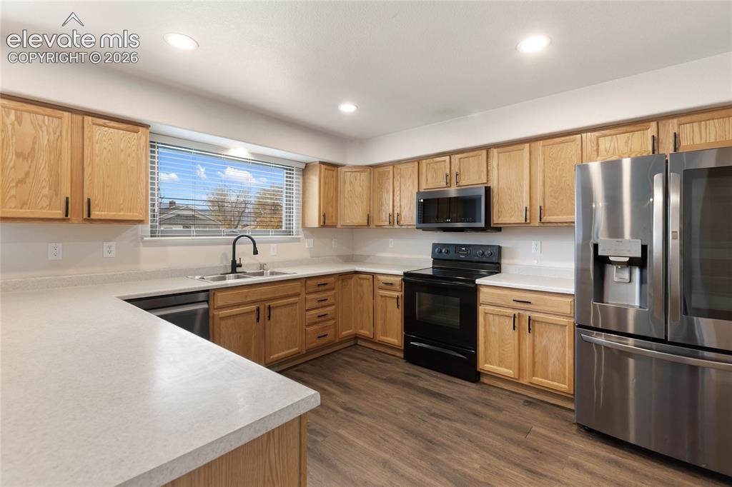 Image 13 of 38: Kitchen featuring light wood cabinetry, light countertops, stainless steel 