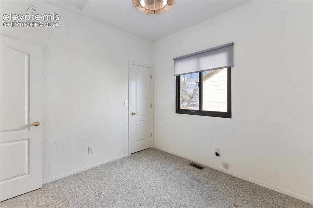 Image 25 of 38: Neutral wall tones with light-toned carpeting