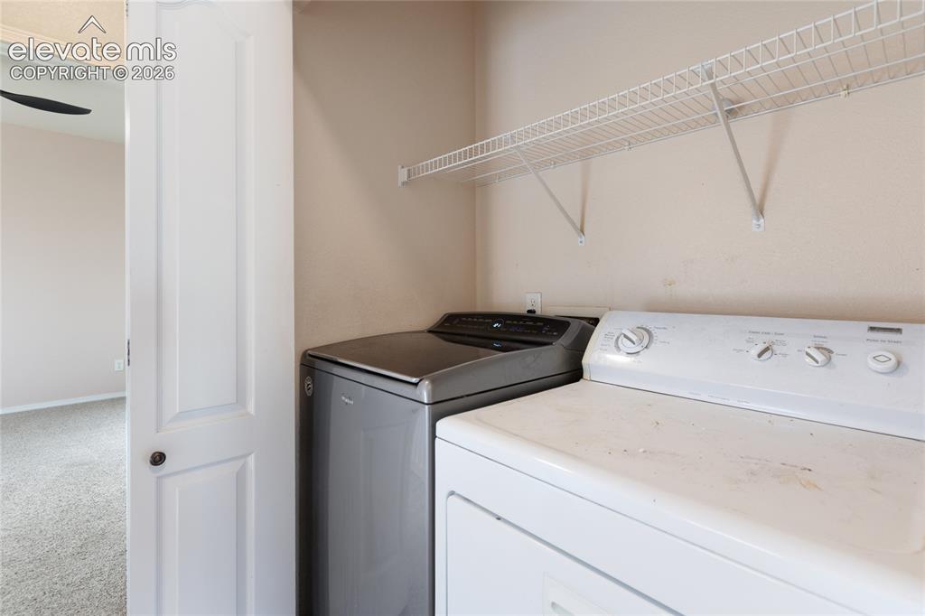 Image 27 of 38: Utility area featuring a wall-mounted wire shelf *Washer & Dryer not includ