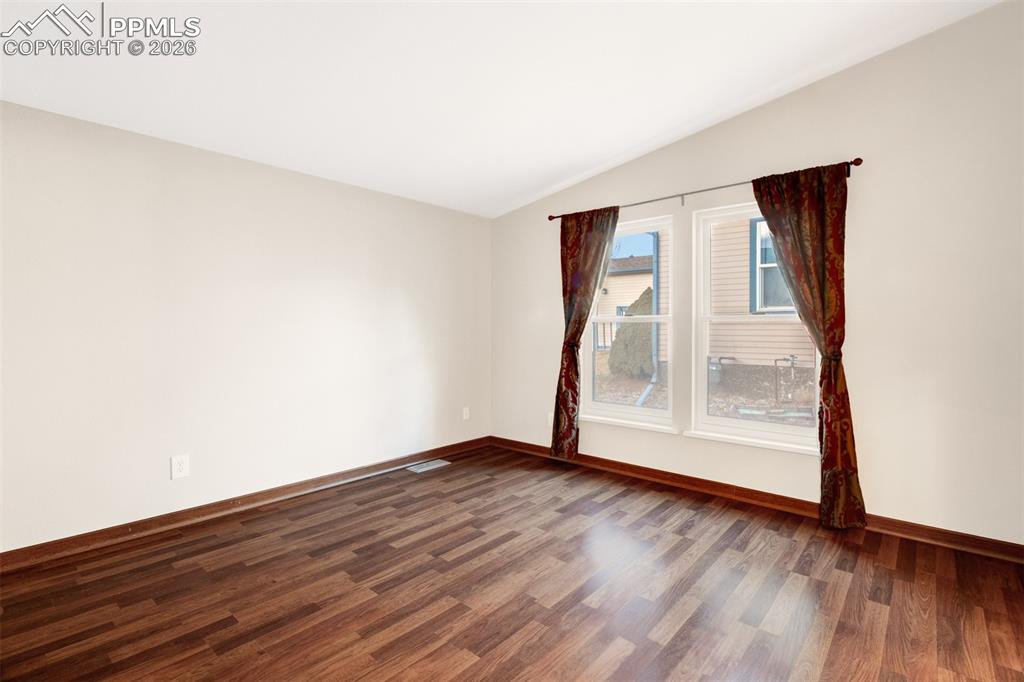 Image 11 of 26: Master bedroom with a large window