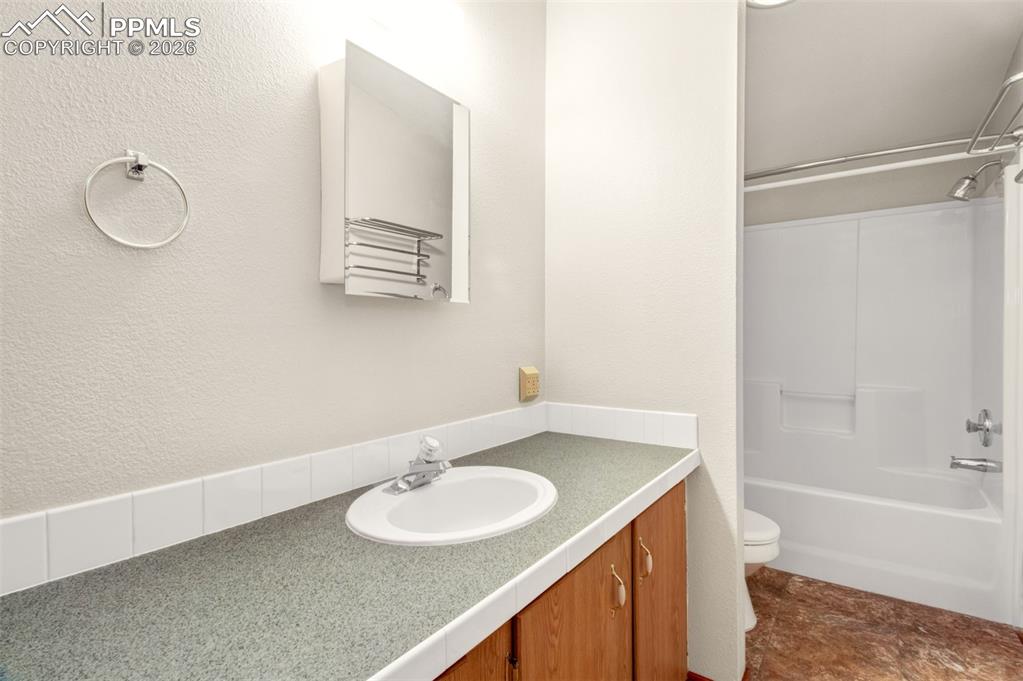 Image 12 of 26: Master bathroom with vanity and tub/shower combo