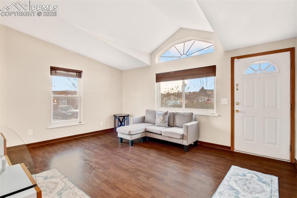 Image 3 of 26: Large, open living room and entry with vaulted ceilings