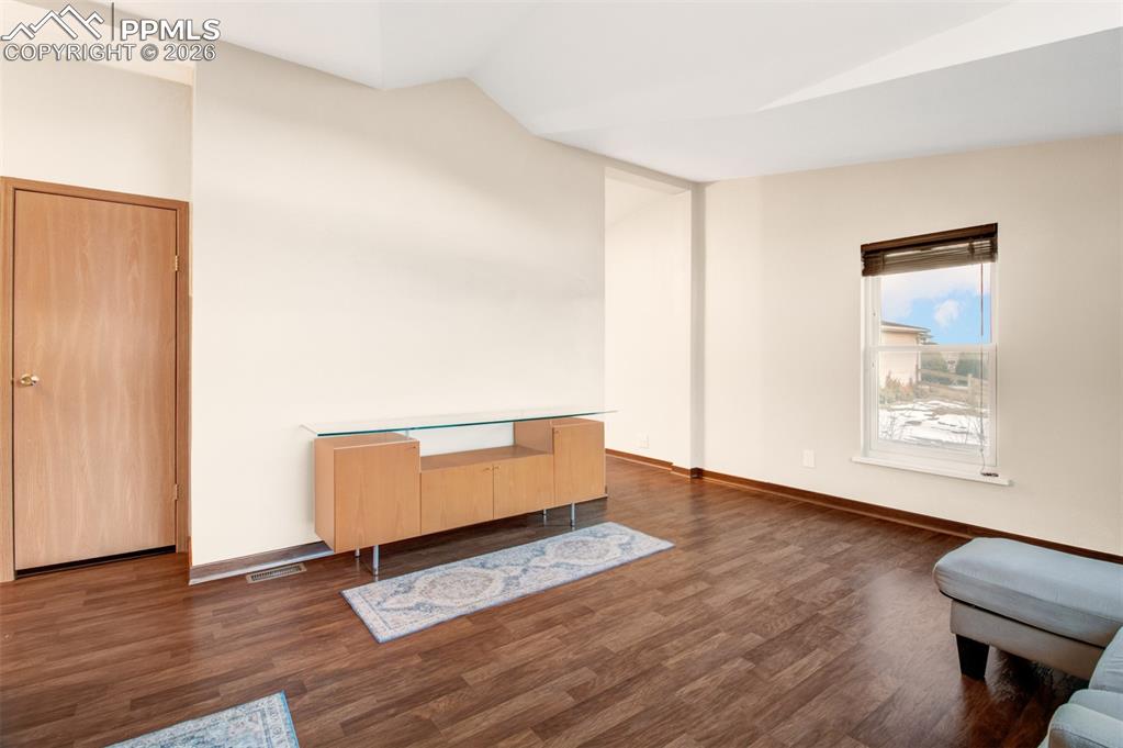 Image 4 of 26: Living room with wood laminate floors and great natural light