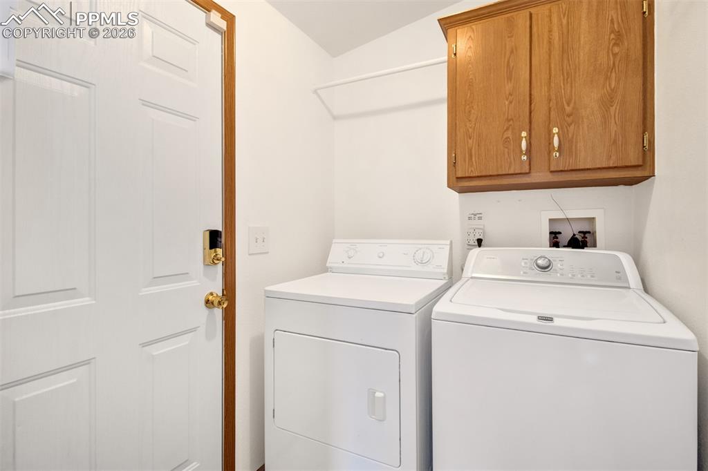 Image 6 of 26: Laundry room with electric hookups and a door to the 2 car garage