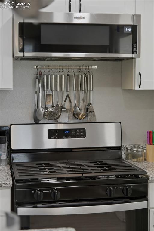 Image 5 of 19: Kitchen featuring a stainless steel microwave, a stainless steel range with