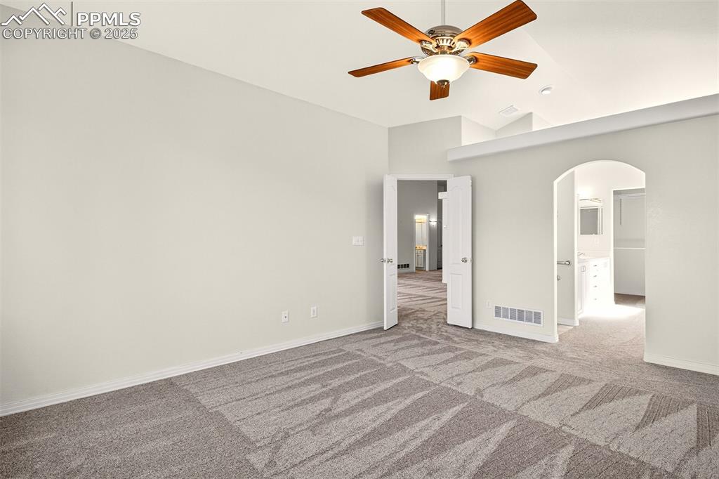 Image 15 of 41: Spacious primary bedroom leading to a private en-suite bathroom