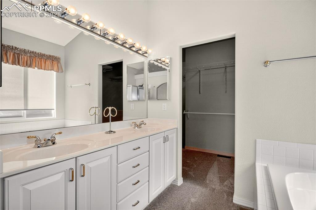 Image 16 of 41: Primary bathroom with double vanity