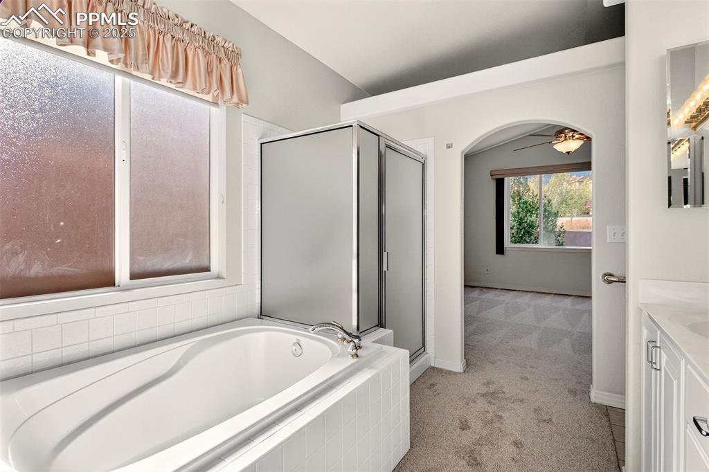 Image 17 of 41: Primary bathroom featuring a separate shower and soaking tub