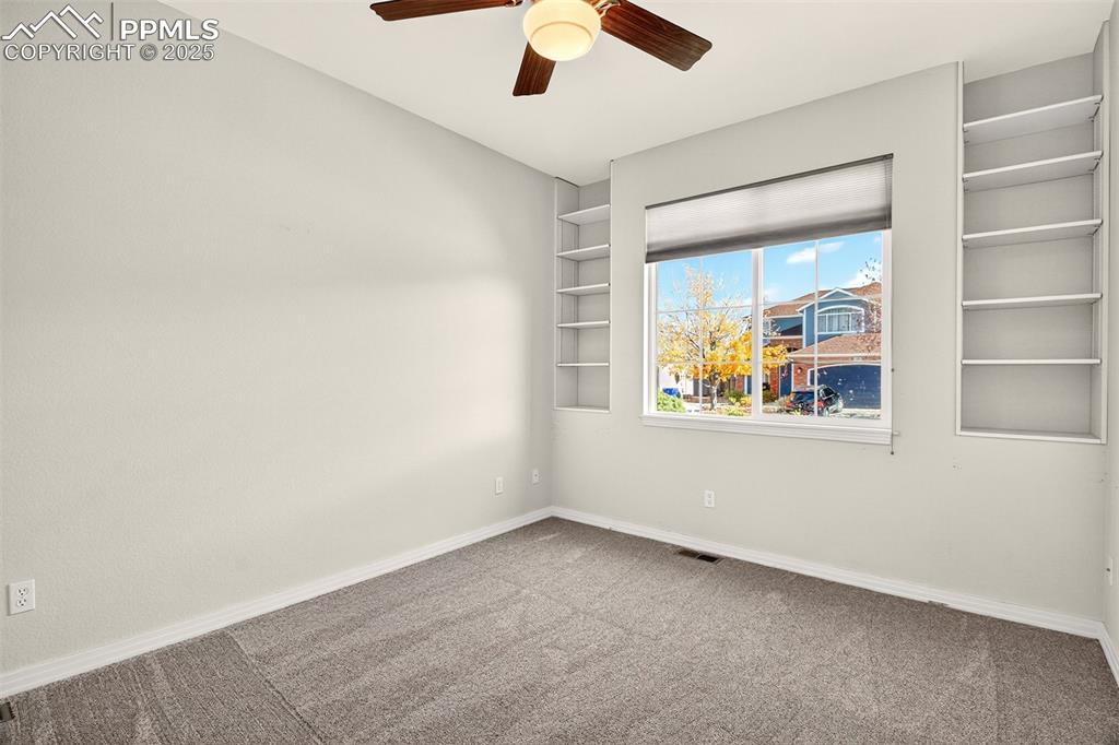 Image 19 of 41: Main floor bedroom with flexible use as an office or guest room