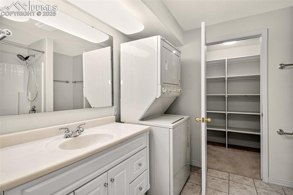 Image 31 of 41: Basement bathroom with washer & dryer and walk-in storage