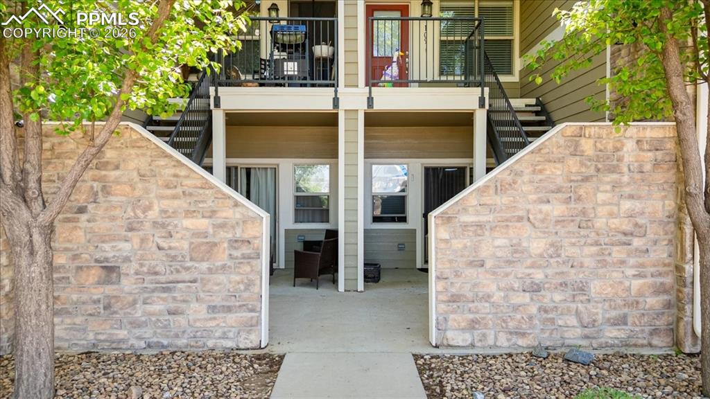 Image 1 of 35: Lower-level patio area featuring concrete flooring and a stone-clad privacy