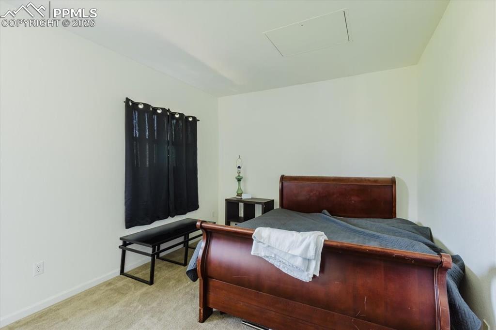 Image 11 of 35: Carpeted room featuring a window with dark curtains, white walls, and a cei