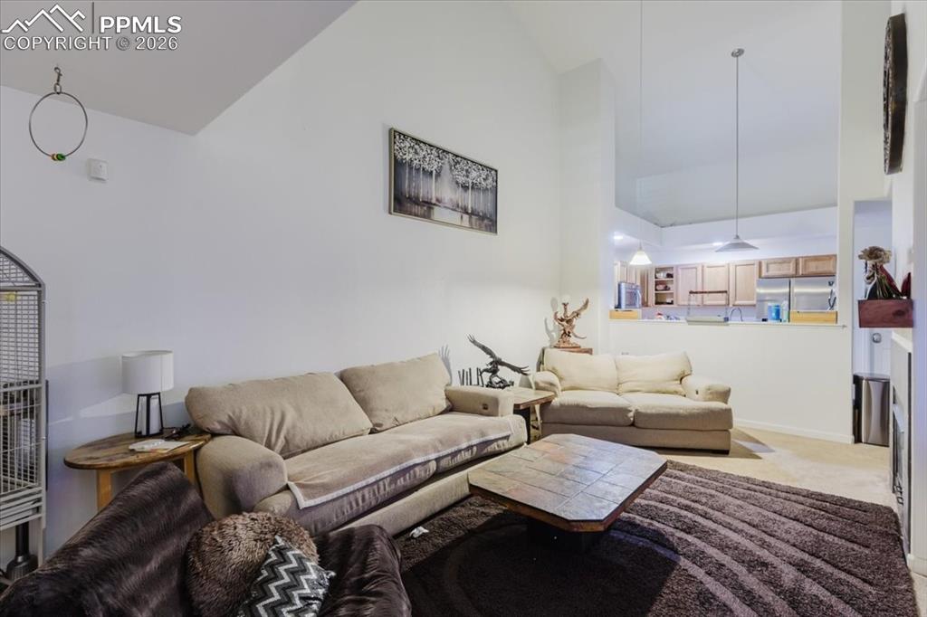 Image 14 of 35: Living area featuring vaulted ceilings and recessed lighting