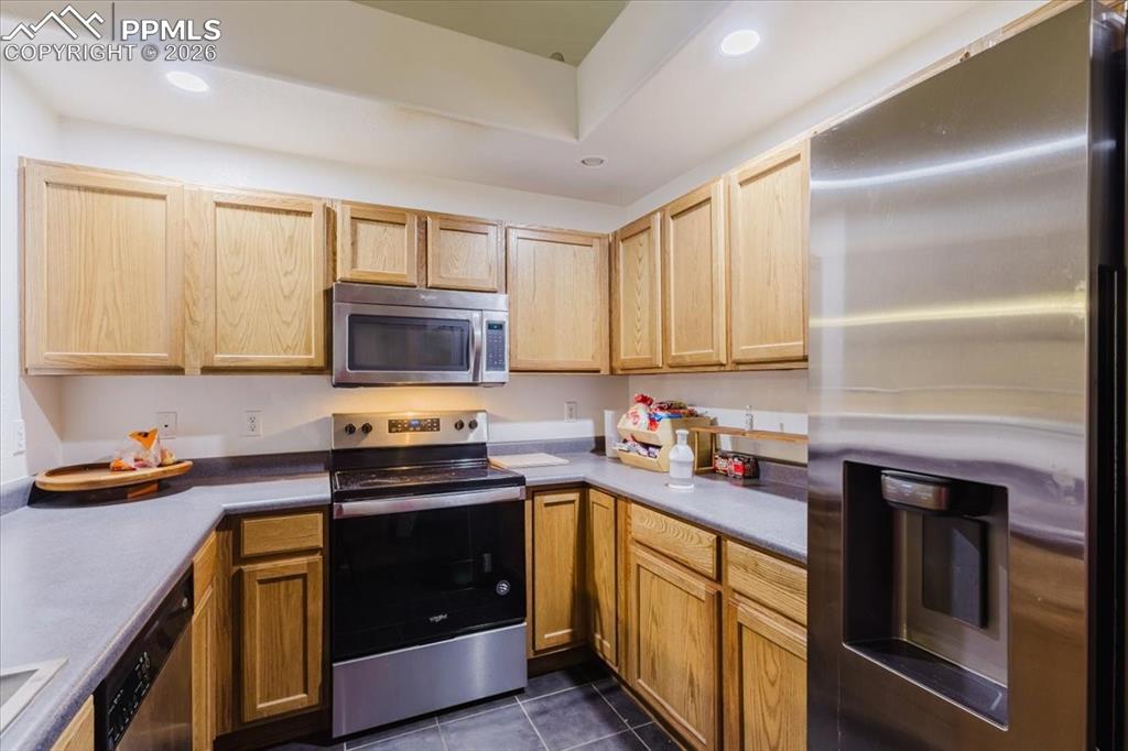 Image 20 of 35: Kitchen featuring light wood cabinetry, stainless steel appliances includin