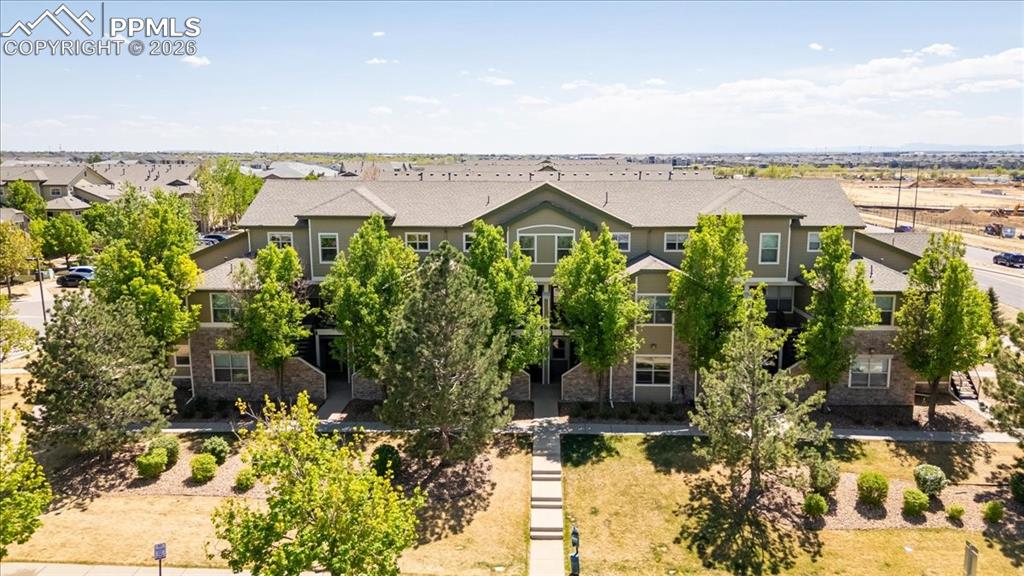 Image 6 of 35: Multi-level residential building featuring a combination of siding and ston