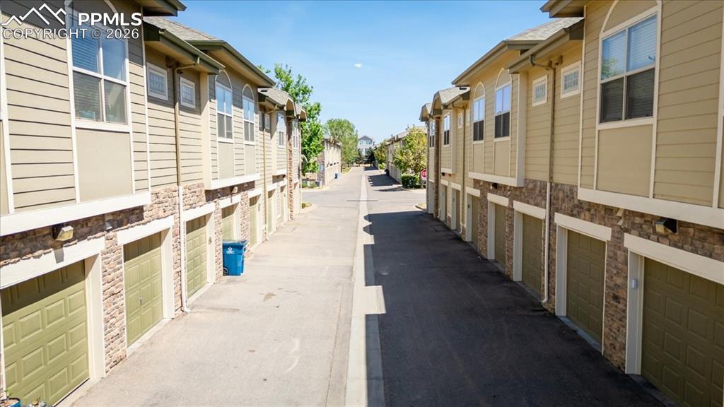 Image 8 of 35: Row of residential units featuring individual garage access