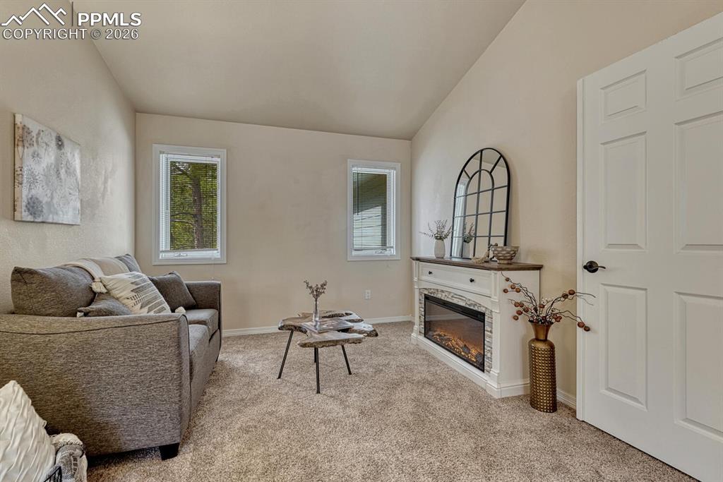 Image 29 of 50: Sitting Room in the Upper Level Primary Suite that includes an electric fir