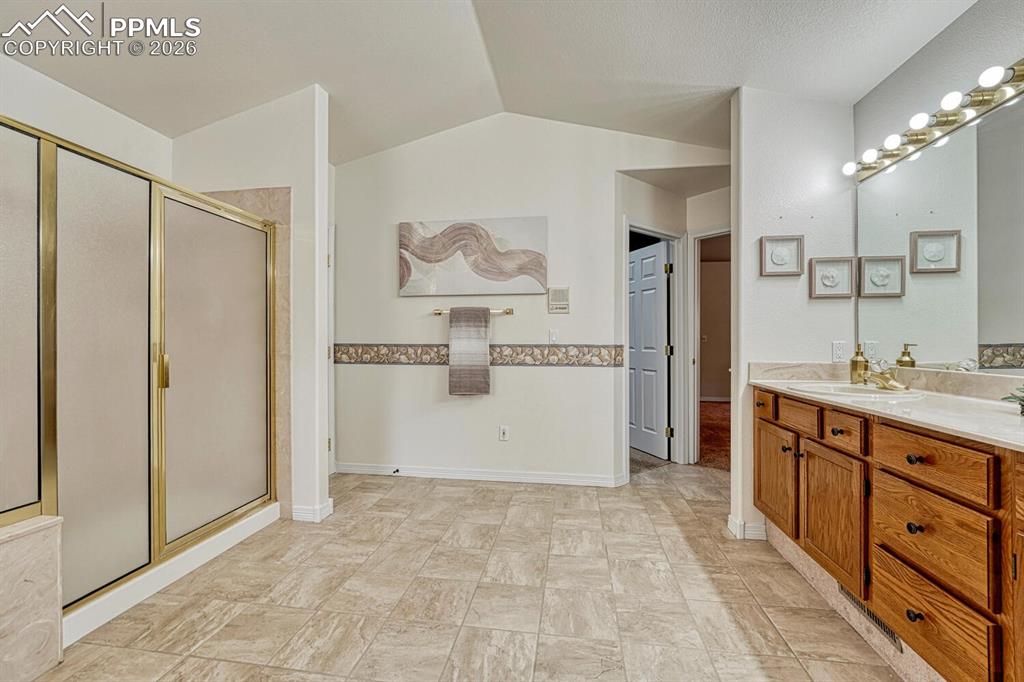 Image 34 of 50: Primary Bathroom with separate tiled shower with built-in seating.