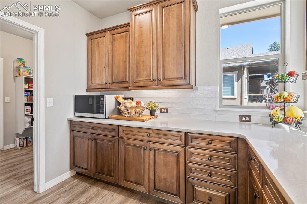 Image 13 of 50: Butlers pantry adjacent to the dual entry walk-in pantry!