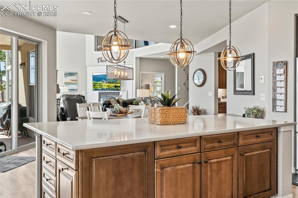 Image 14 of 50: Kitchen featuring light countertops, light wood-style flooring, pendant lig