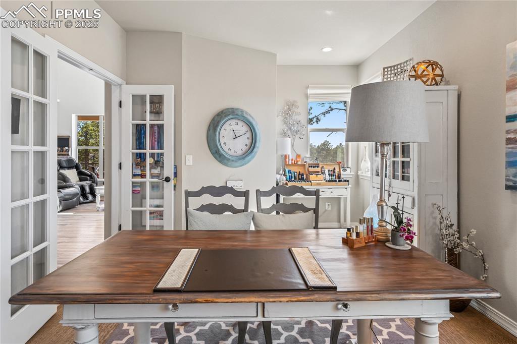 Image 32 of 50: Main floor office, glass french doors, carpet, tons of natural light