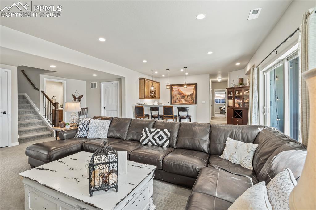 Image 34 of 50: Walk-out basement living room with wet bar