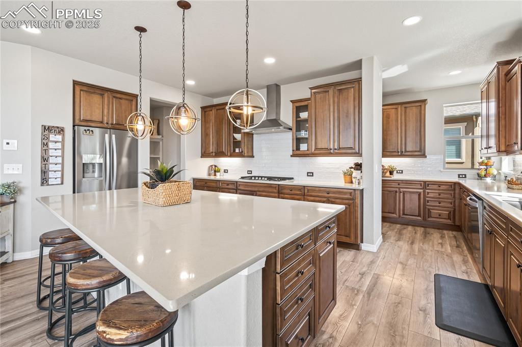 Image 9 of 50: Quartz counters, LVP flooring throughout main floor