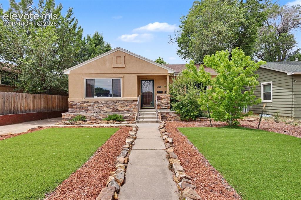 Image 1 of 36: Stucco exterior featuring a stone facade and a prominent front entry