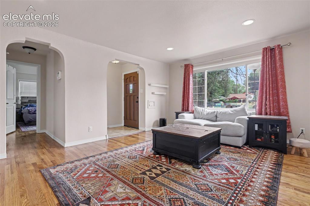 Image 4 of 36: Living area featuring wood-finish flooring, recessed lighting, a large wind