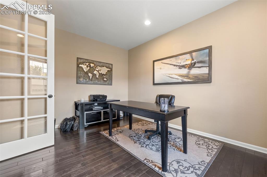 Image 2 of 46: Home office with dark wood finished floors and recessed lighting