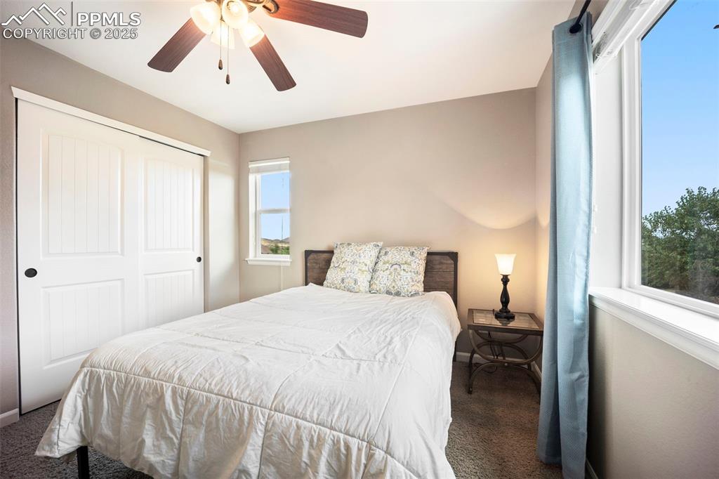 Image 23 of 46: Carpeted bedroom featuring a closet and ceiling fan