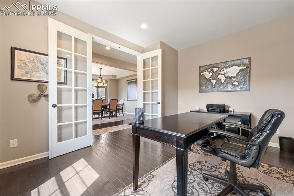 Image 3 of 46: Office space featuring french doors, a chandelier, dark wood finished floor