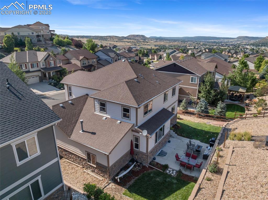 Image 36 of 46: Aerial view of residential area with a mountain backdrop