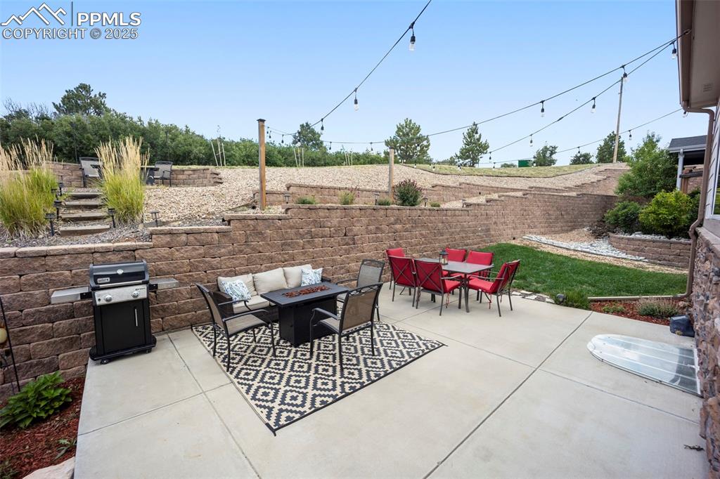 Image 40 of 46: View of patio / terrace with an outdoor fire pit, outdoor dining space, and