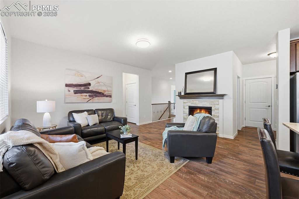 Image 13 of 39: Main level living with cozy stone fireplace!  You are going to love living 