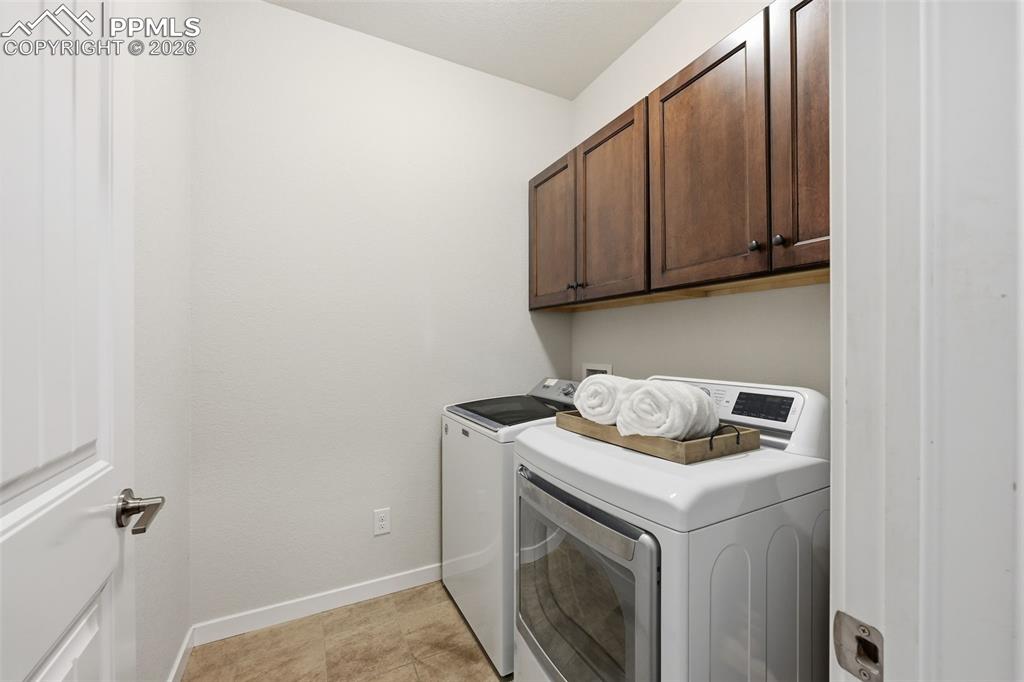 Image 23 of 39: Laundry room with cabinets!