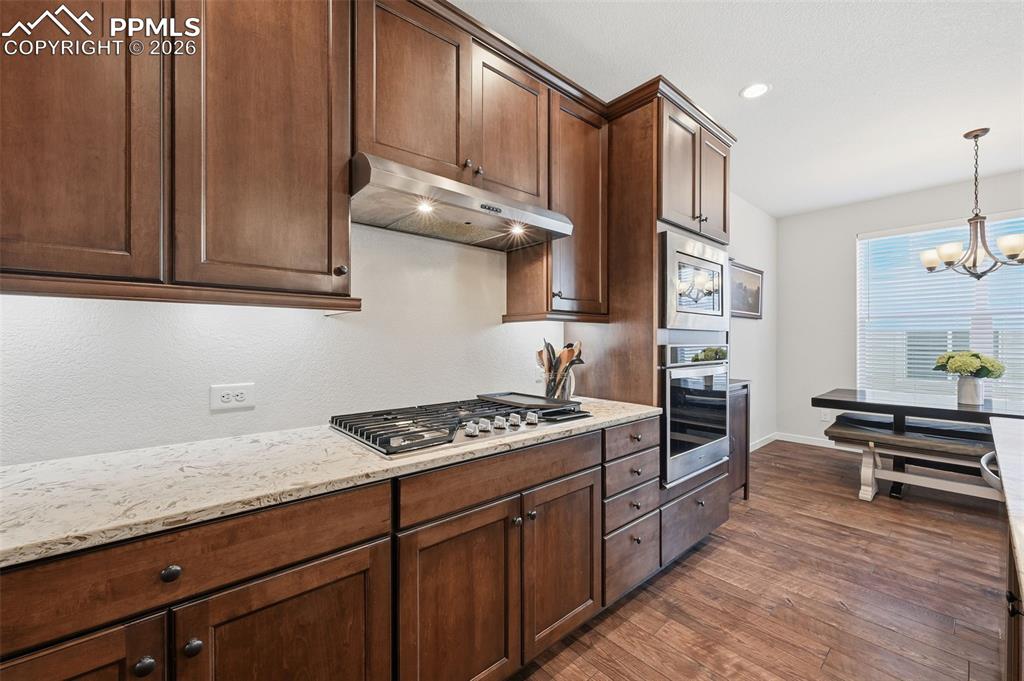 Image 7 of 39: Gas cook top, soft closing upgraded cabinets and wall ovens!