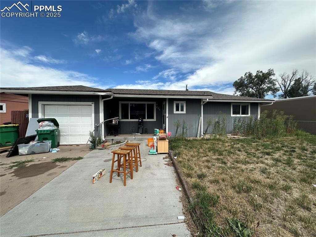 Caption: Ranch-style house with a garage and a shingled roof