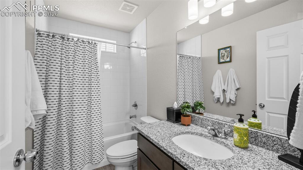 Image 10 of 37: Full bathroom with vanity and shower / bathtub combination with curtain