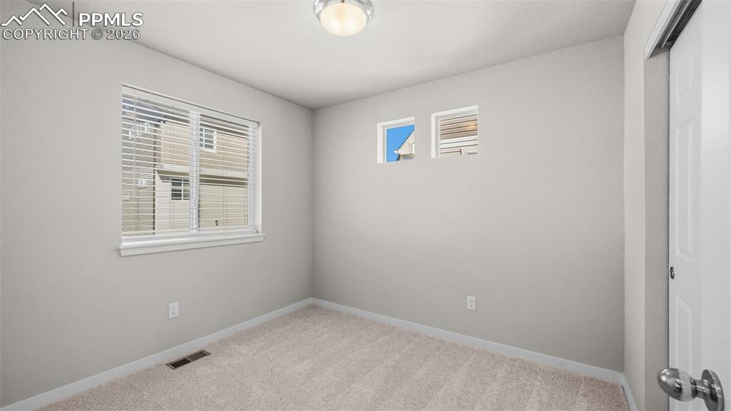 Image 12 of 37: Unfurnished room with plenty of natural light and light carpet
