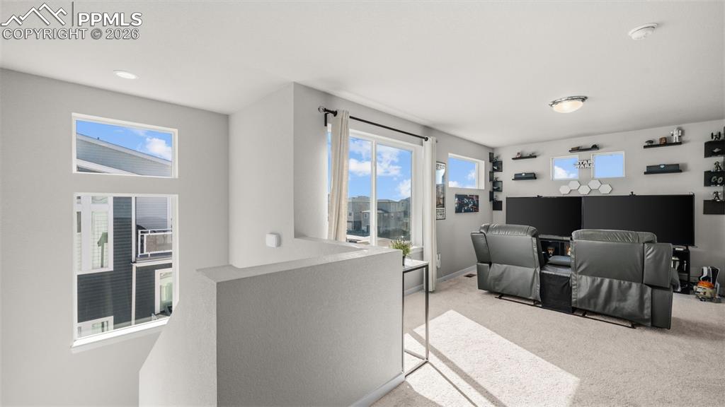 Image 14 of 37: Living area featuring light carpet